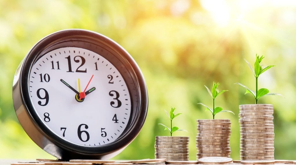 A clock next to pennies